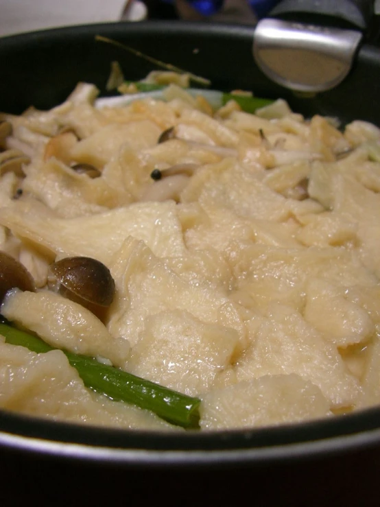 a bowl full of food that includes pasta, vegetables, and meat