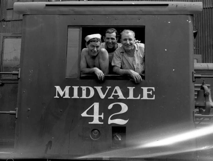 three men are in a middle of a train