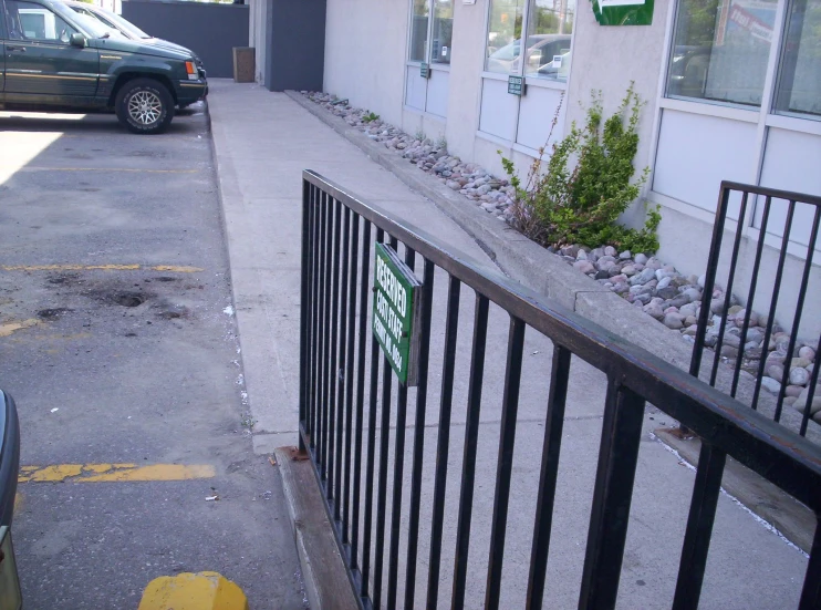 a street is between two buildings and a fence