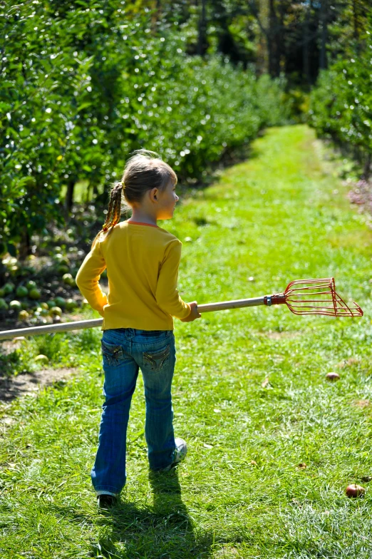  standing on grass holding onto a baseball bat