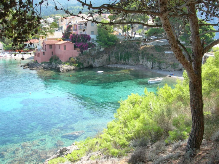 a village sits on a cliff overlooking the sea