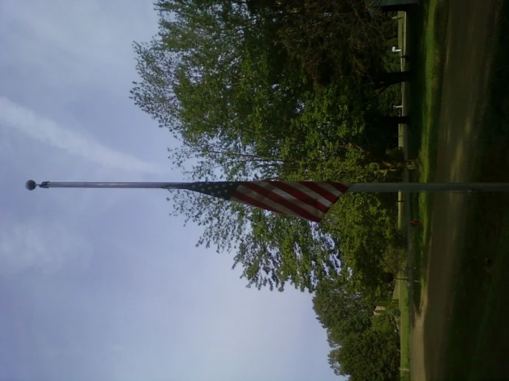 an american flag is hanging on a pole