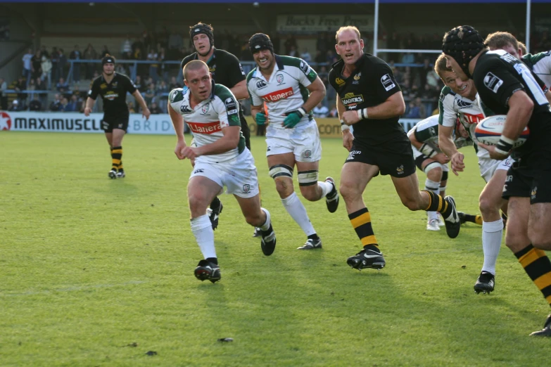 rugby players running after ball during game play