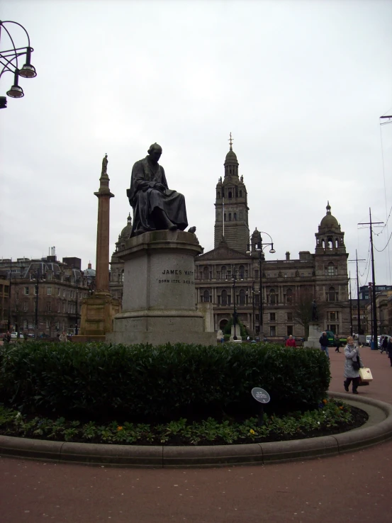 an statue is in the middle of a round garden