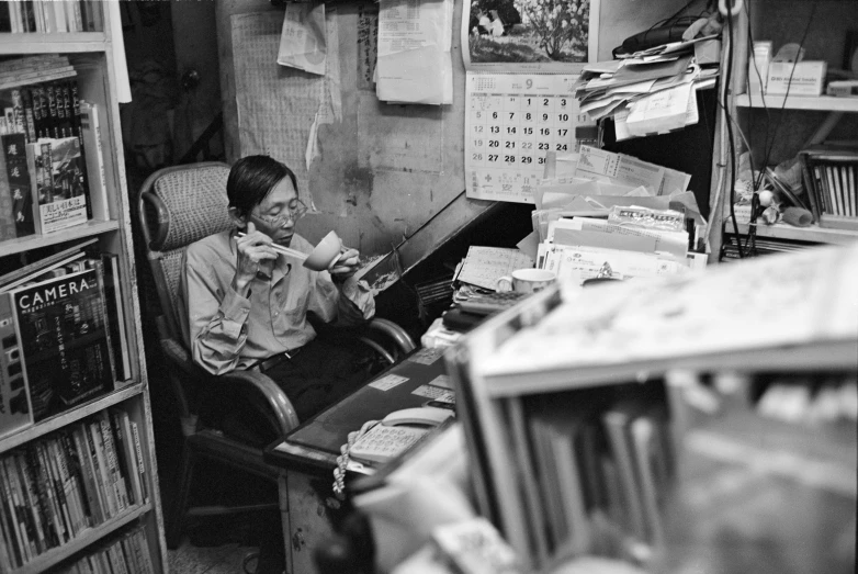 a person sitting at a desk in front of a computer