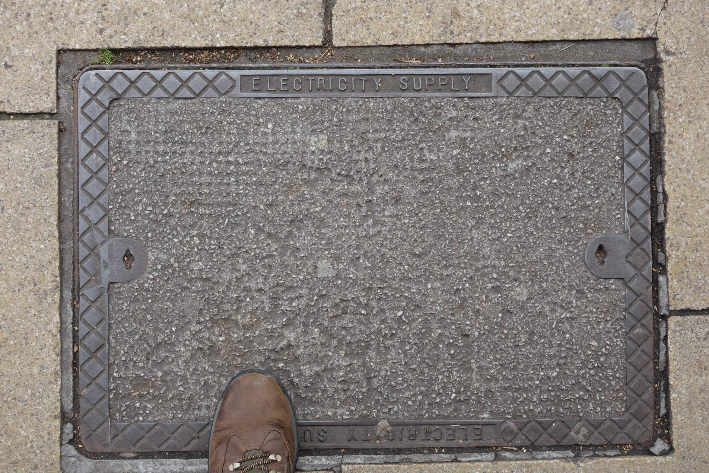 a man standing in front of an door that has a manhole cover