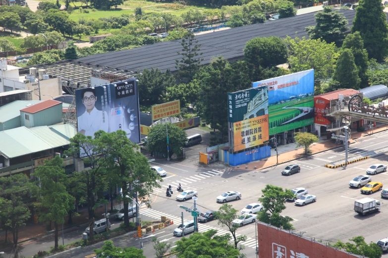 the road view of a street with many vehicles and buildings