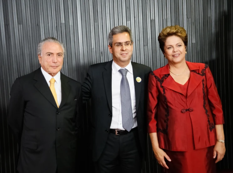 four people in suits and tie posing for a picture