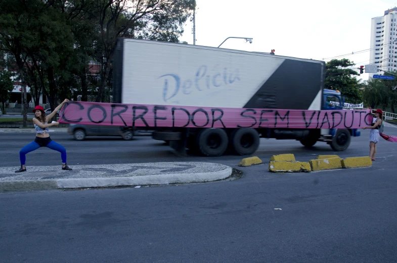 a person on a skateboard and a truck in the road