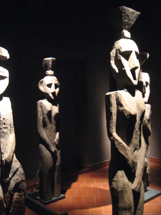 three statues on display at the museum