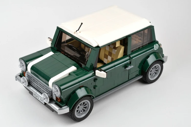 a model of a green and white car on a white surface