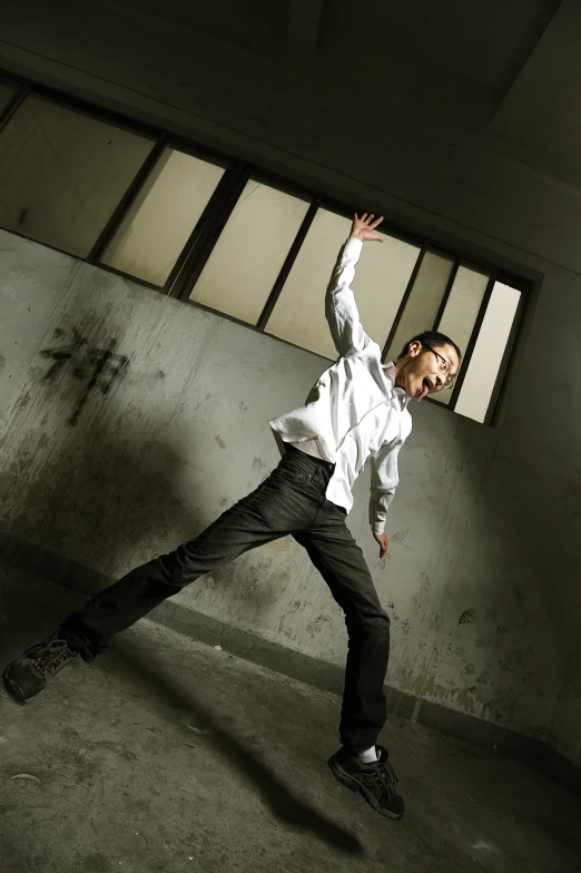 a man jumping in the air with his hand out for a dancing trick