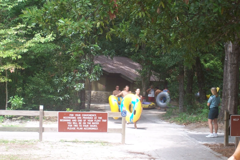 people standing near a forest with several life jackets