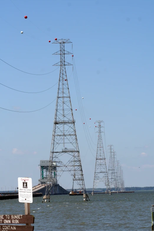 a group of power lines near the ocean