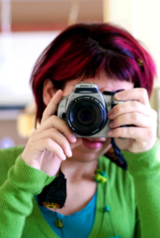 a woman is taking a po with her camera