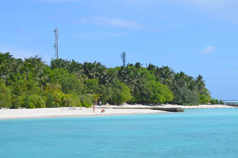 the blue waters are clear and the beach is just off to the left