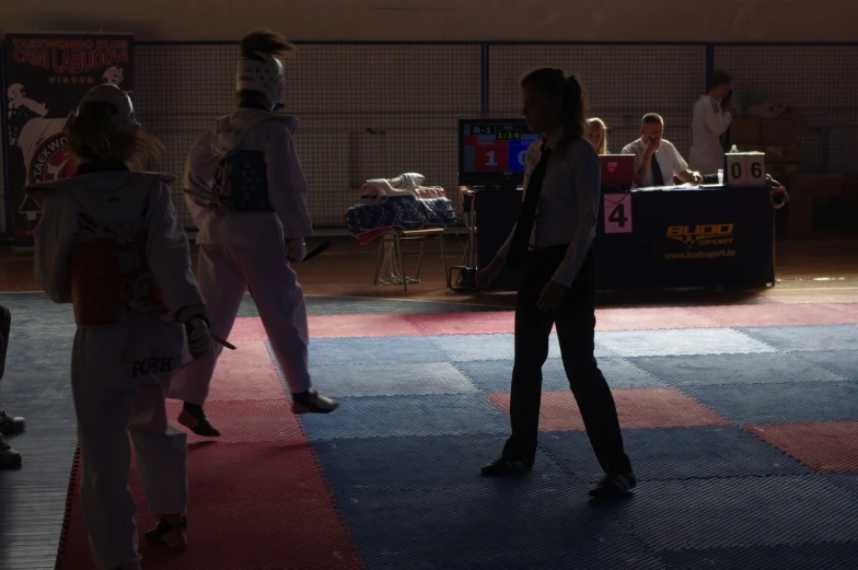 a woman stands on the mat during an individual martial match