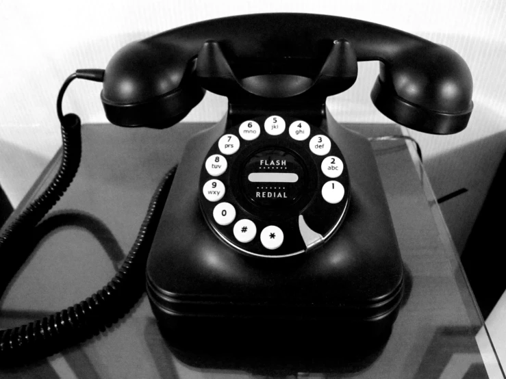 an old - fashioned telephone sitting on top of a table