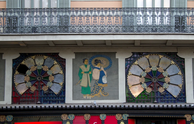 colorful art work on building walls next to metal balcony