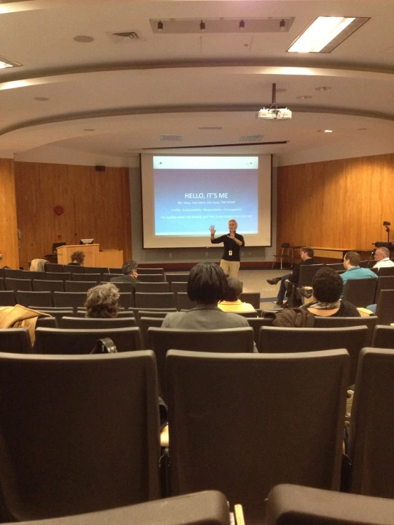 there is an audience watching a lecture in a large auditorium