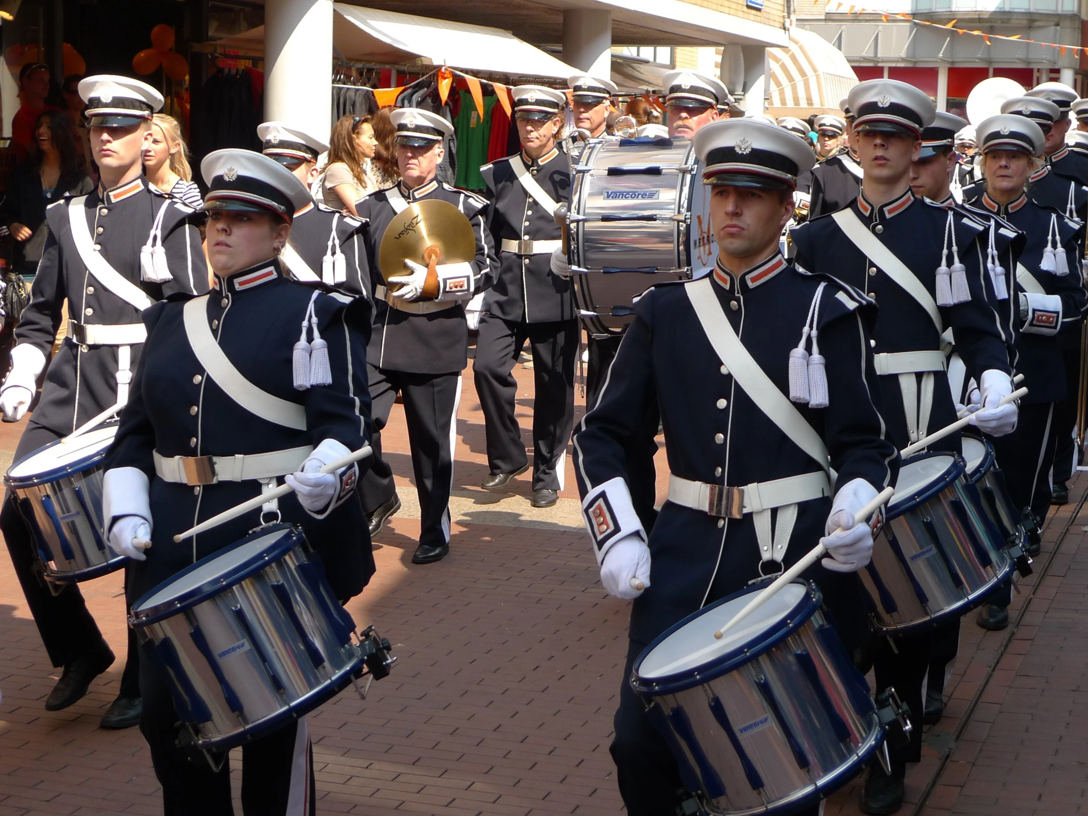 a group of men wearing military uniforms are marching through the street