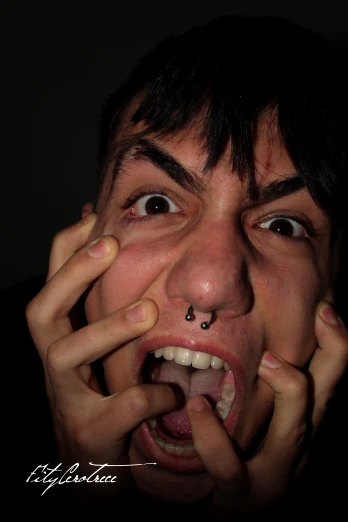 a man with piercings on his nose and a nose ring