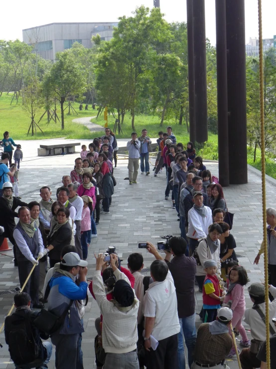 an outdoor concert of people standing around talking to each other