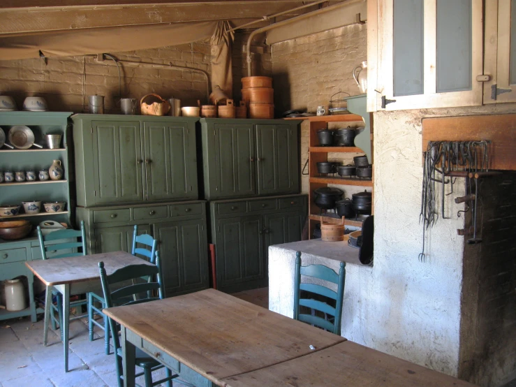 many kitchen cabinets and chairs in a room