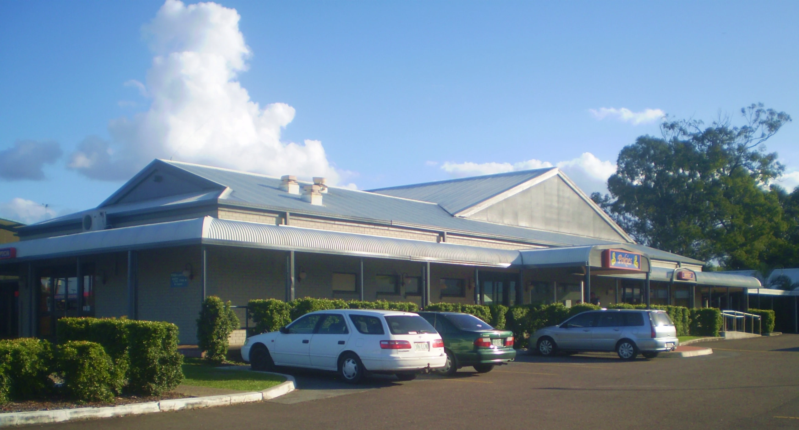 a view of a building in a city parking lot