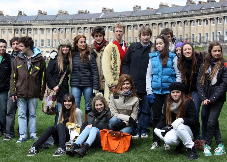 a group of young people in front of buildings