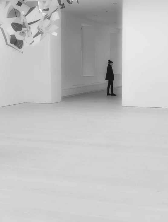 a person standing next to an art installation