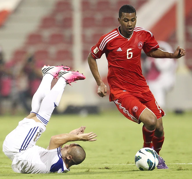 two soccer players vie for the ball during a game