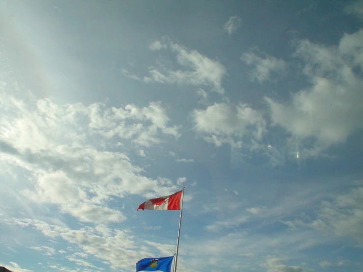 two flags that are flying in the air