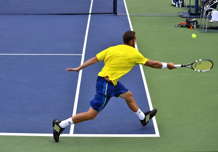 a man on a tennis court with a racket