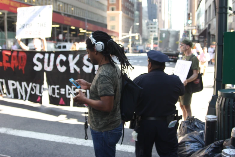 two men with headphones standing near a street
