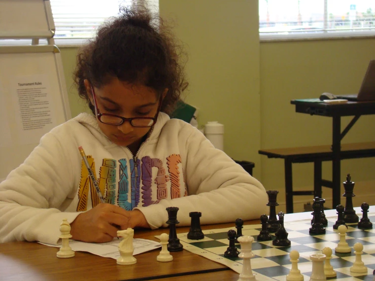  in glasses playing a game of chess