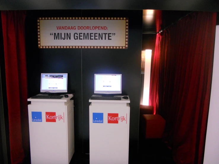 a group of people using laptops at a exhibit