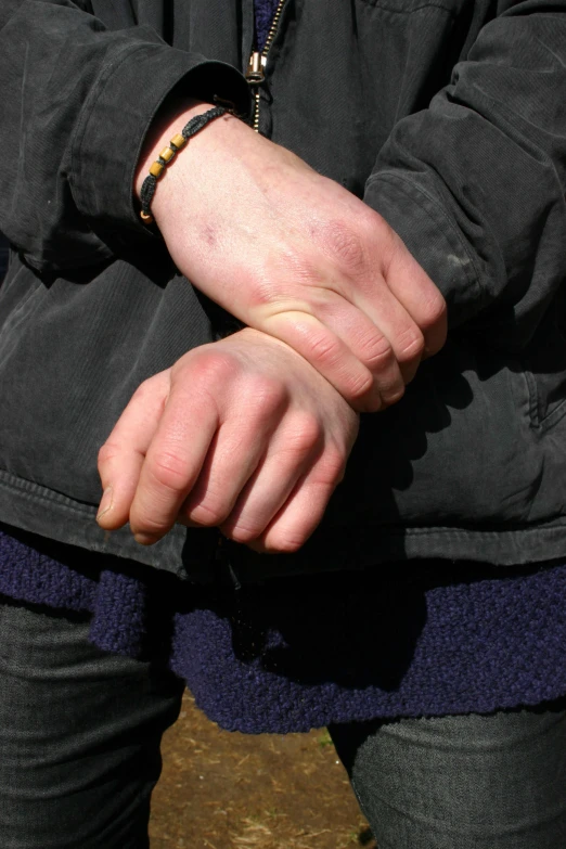 a person holding onto soing by their hand