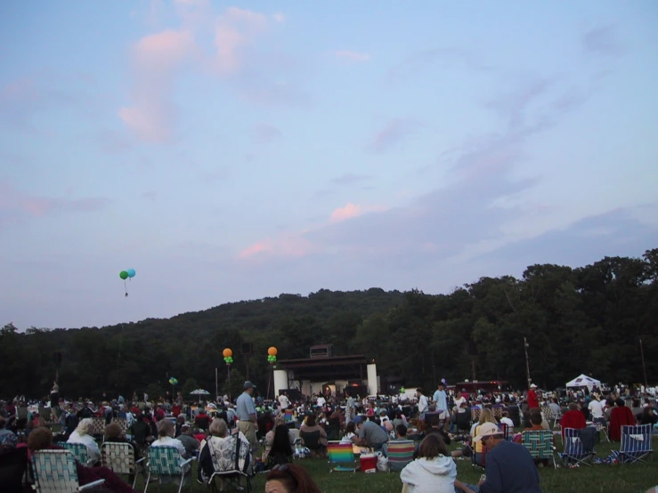 a bunch of people sitting and standing around at an event