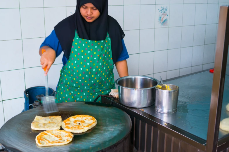 a woman preparing quesadillas for dinner on the grill