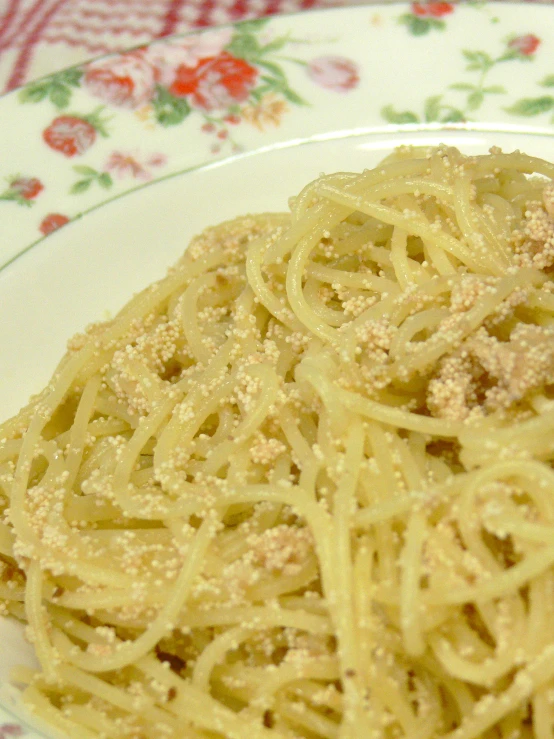 there is a plate with pasta on the table