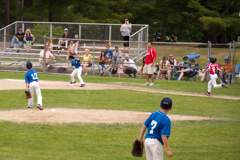 young children playing baseball during a youth league game