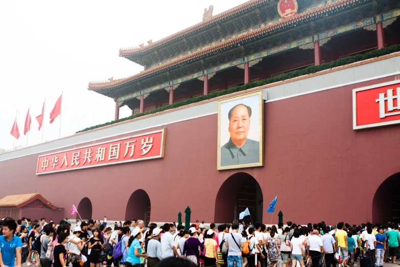 a crowd of people are lined up outside a large building