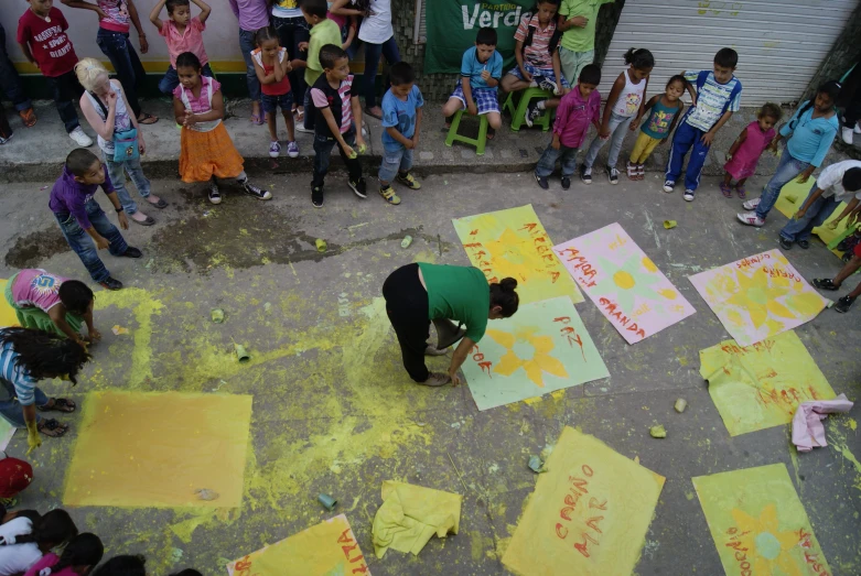 young children at a street festival getting ready to decorate their art