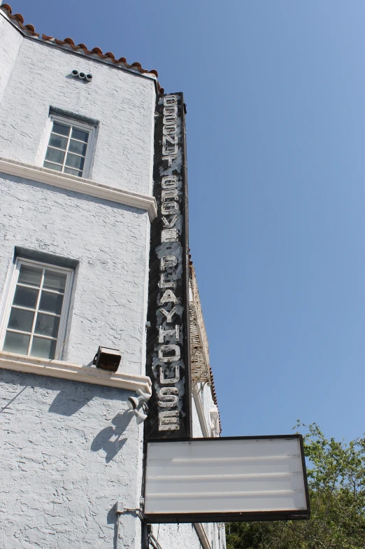 the sign for the historic movie theater, with a clear sky in background