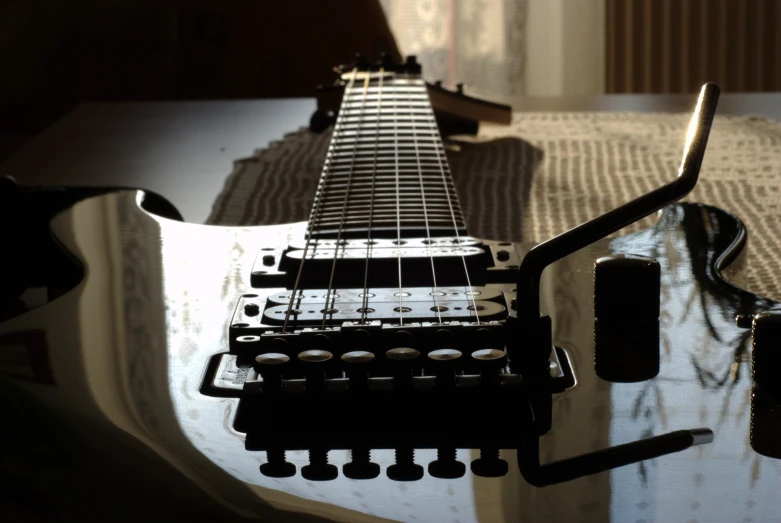 a guitar is laying on top of some white sheet