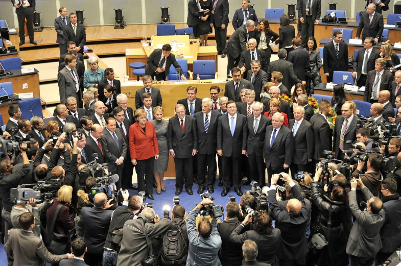 group of people in suits and ties taking pictures