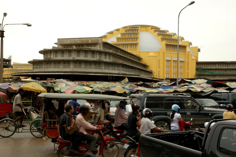 an intersection with many people and some umbrellas