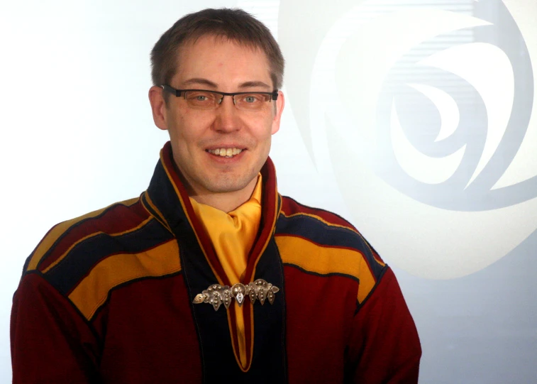 man wearing glasses and a gold neck tie