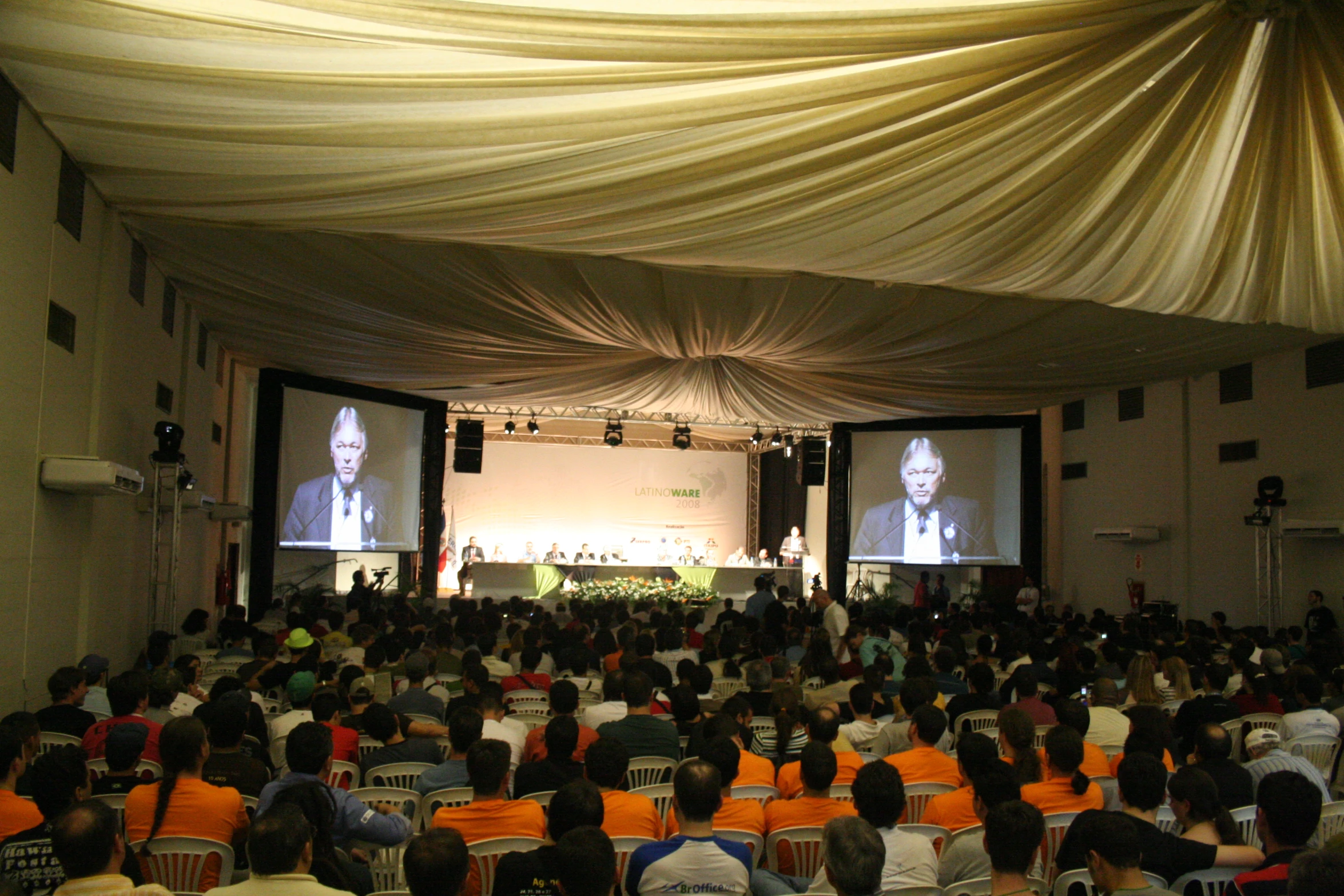 large crowd watching a film in a room